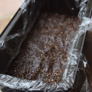 date and nut mixture in clingfilm in a tin