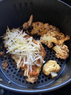 Chicken topped with pesto and cheese ready to cook