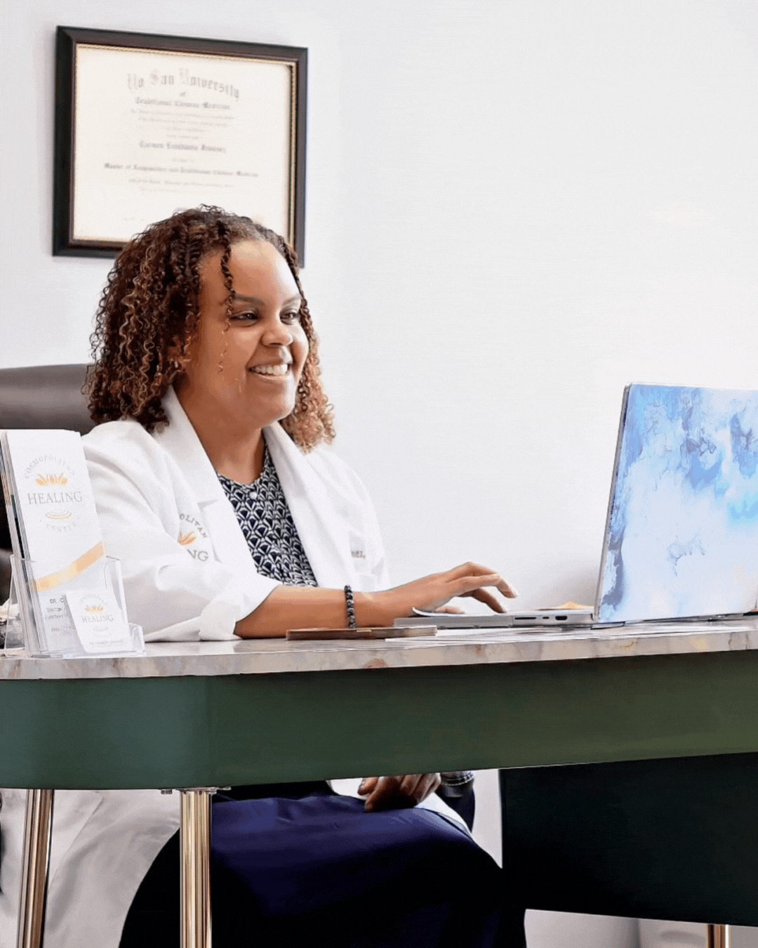 Photo of Dr. Carmen Jiménez working on laptop.