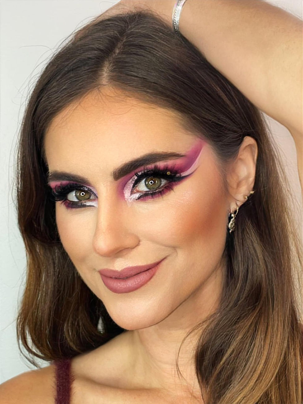 Woman with bold pink eyeshadow, Mugshot Makeup Artis, and soft makeup look.