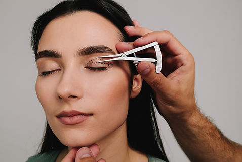 Upper blepharoplasty Plastic surgeon is measuring surgical distance within eye of his pati