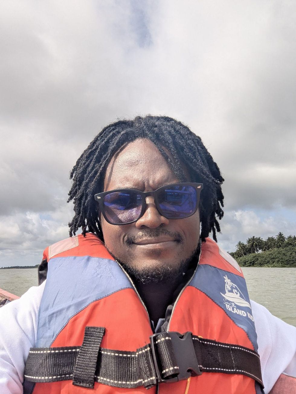Guide Kophi wearing a life jacket on an Ada estuary boat tour