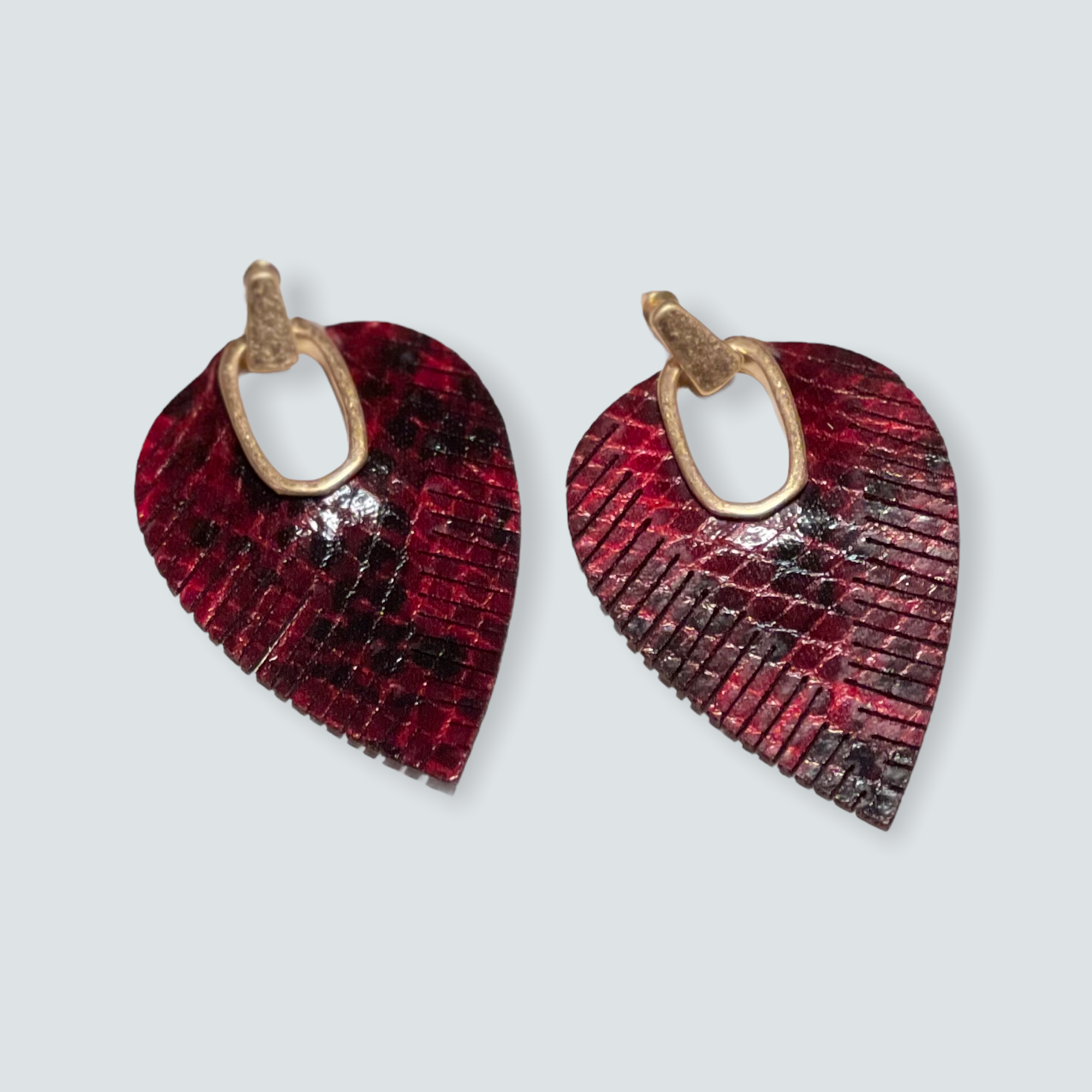 Red and black leather leaf-shaped earrings, fashion and style accessories.