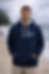 Male on the beach wearing dark blue hoodie with Each One Wild Logo