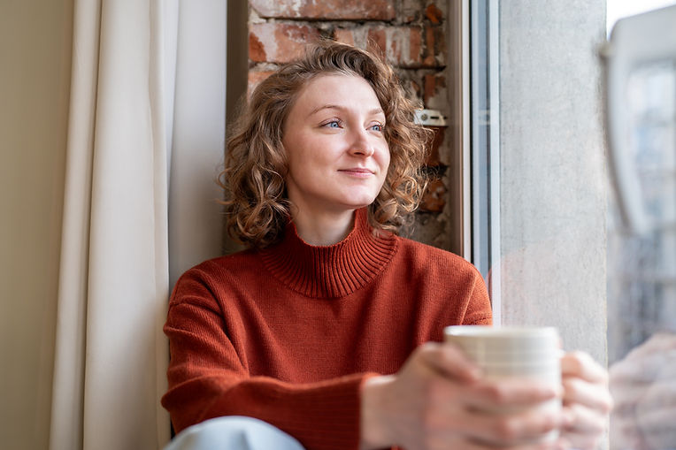 Happy relaxed woman enjoying quiet time simple joys holding coffee mug, lost in positive t