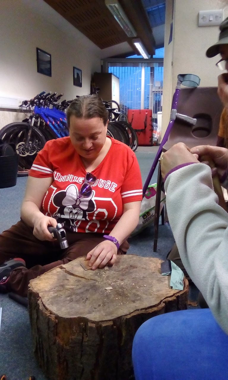 A lady using a drill.