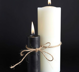 one white taper candle and one black taper candle tied together with jute cord.jpg