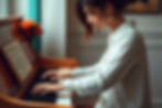 woman playing piano with neutral colors and warm teal and orange.jpg