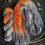 Thumbnail: Hand dyed yarn. 75% gray, 25% rich orange with a bit of white seeing through.