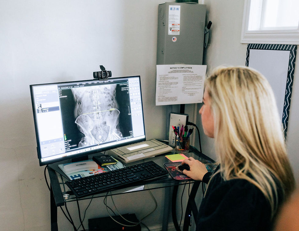 Dr. Caroline reviewing a spinal X-Ray before starting a spinal adjustment.