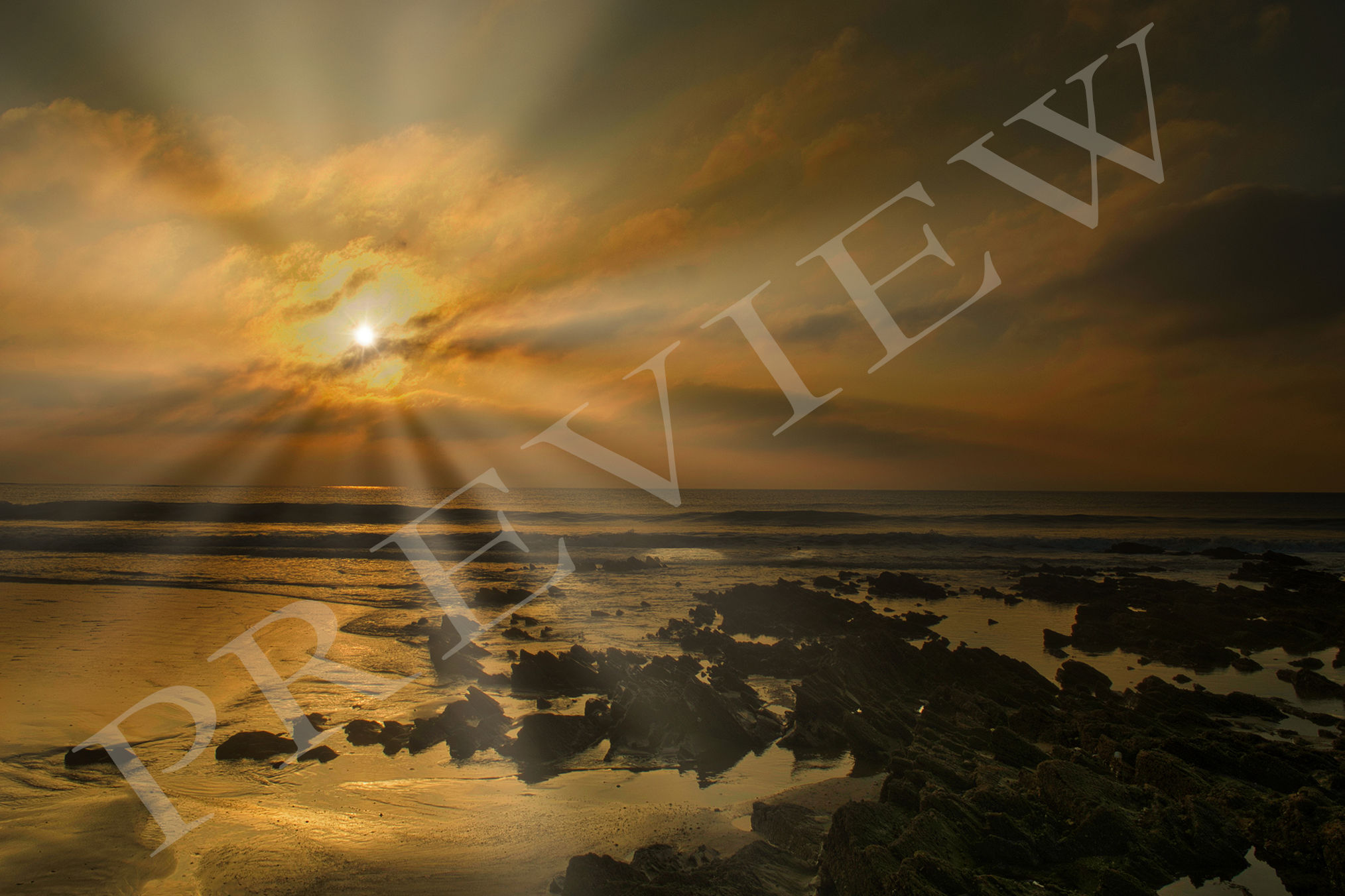 Dramatic Rays Over a Rocky Beach at Sunset