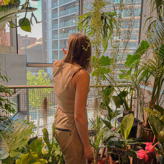 a girl surrounded by plants
