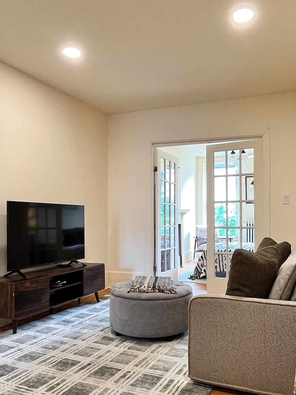 Eye-level view of a bright and neatly staged living room with neutral colors