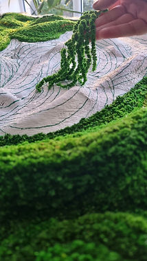 hand holding preserved amaranth over a work in progress sculptural plant artwork.jpg