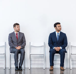 businessmen-in-suits-sitting-on-chairs-at-white-wa-2024-11-19-17-58-27-utc.jpg