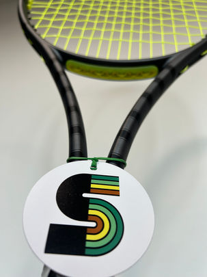 The My Stringer brand circle shaped swing tag label on the handle of a tennis racquet