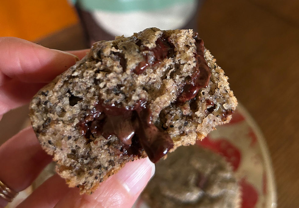 Eye-level view of a cooling rack with buckwheat banana muffins wrapped in a linen cloth