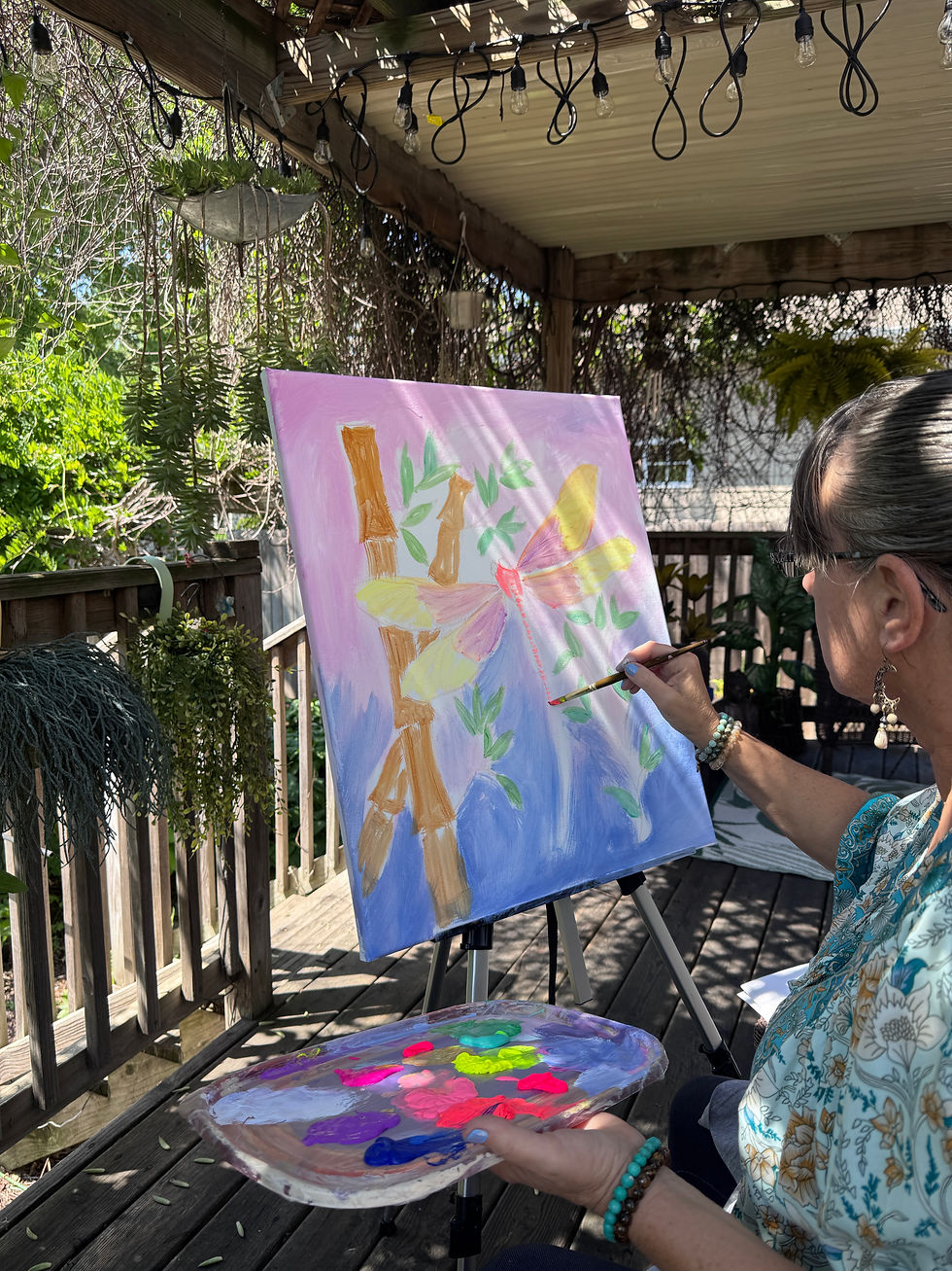An artist enjoys a tranquil painting session in a lush outdoor garden, surrounded by vibrant colors and natural beauty.