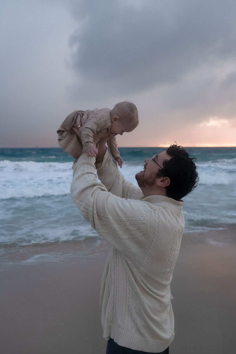 A dad holding his daughter on a dark and rainy day in perth