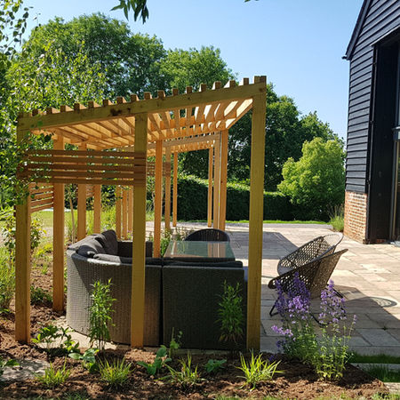 Close up view of shade pergolas surrounded by newly planted beds