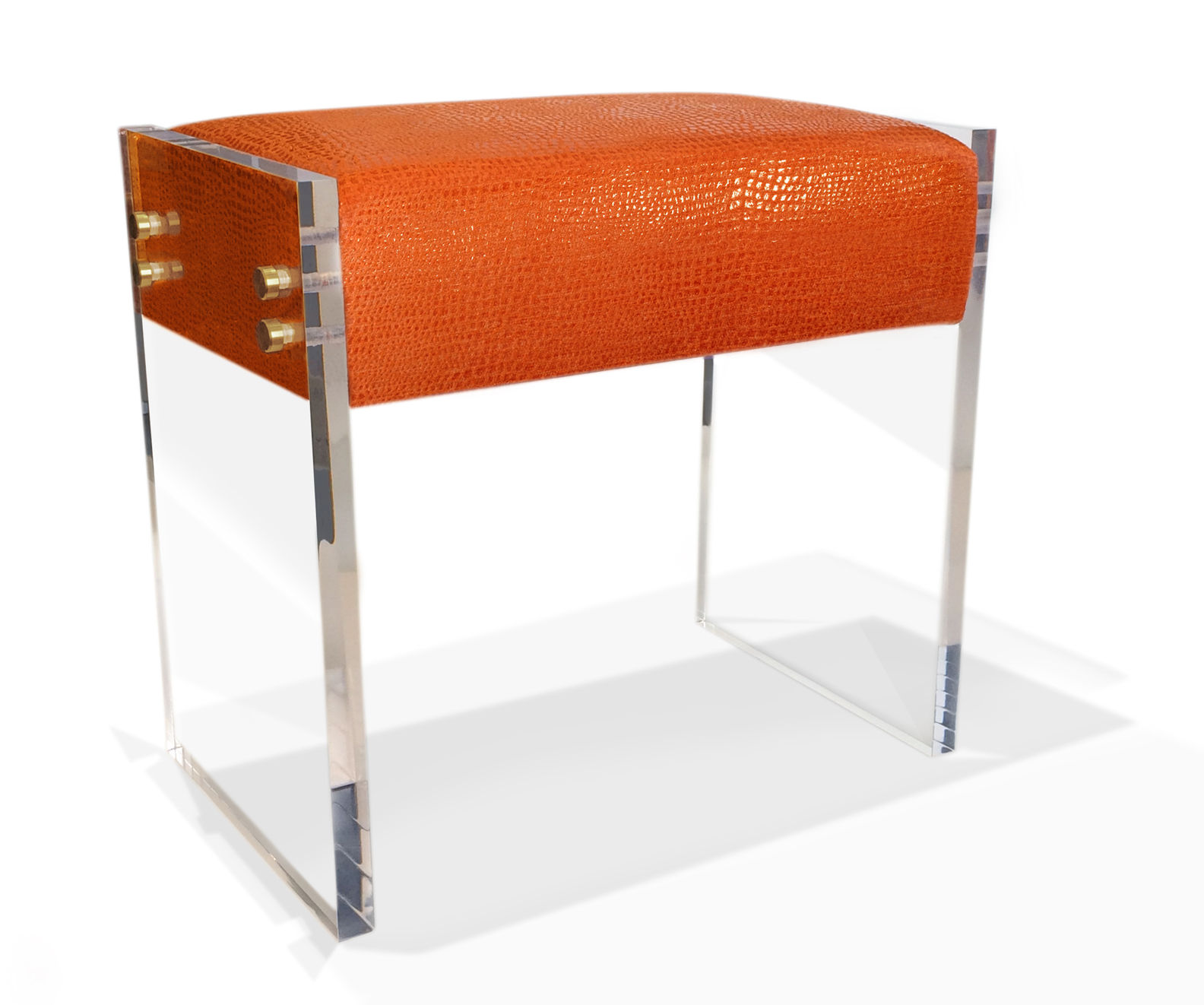 Claudia Bench features two Lucite legs connected to the bench seat with Anodized Brass.
