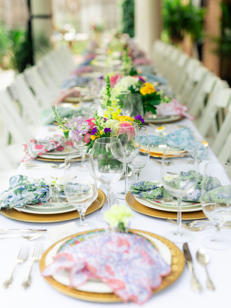 Outdoor wedding table with colorful napkins and flowers