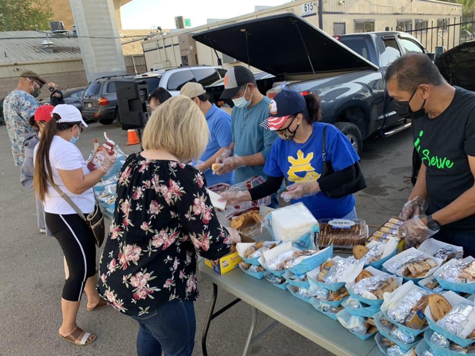 Volunteers preparing and distributing food at a community pantry event