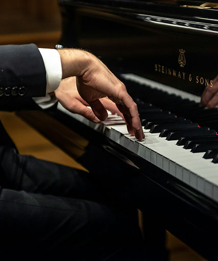 Close-up of piano lesson showing hands on keys during student instruction at KW School of Music in Waterloo