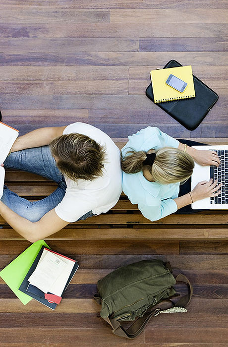 Male and female students doing schoolwork