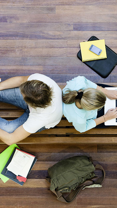 Male and female students doing schoolwork