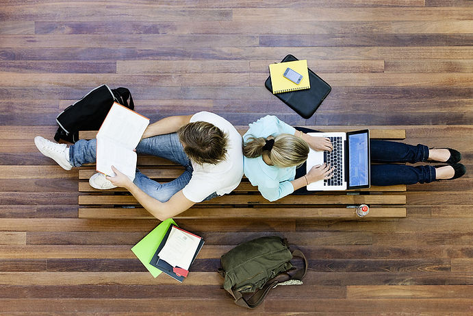 Students doing practice on laptopMale and female students doing schoolwork