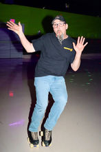 Enthusiastic skater enjoying open skating at Castle Roller Skating indoor rink.