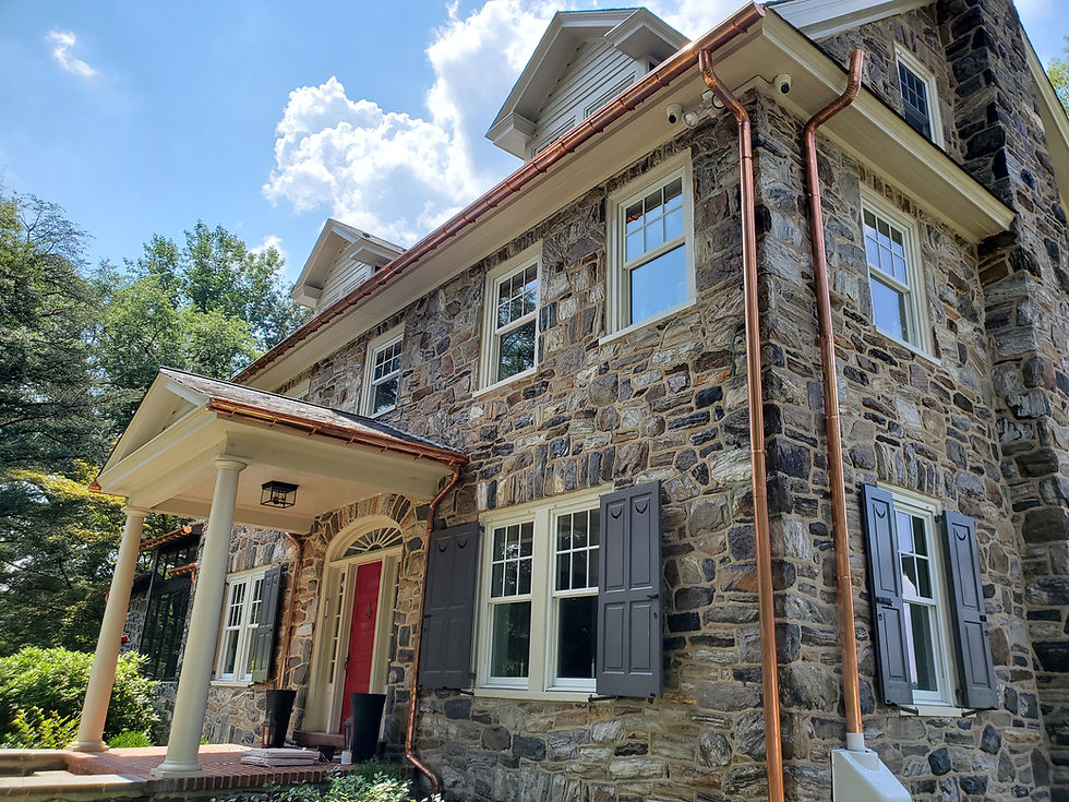 Corner view of a house with new gutters