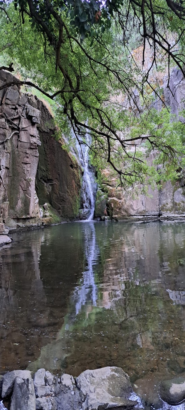 Mirror-still afternoon, the falls doubled in reflection