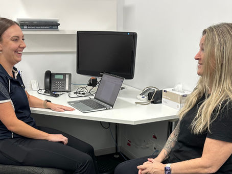 Exercise physiologist speaking with a client during an initial consultation at Functional Wellbeing.