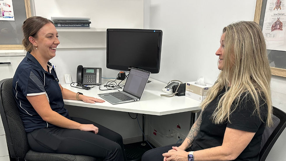 Exercise physiologist speaking with a client during an initial consultation at Functional Wellbeing.