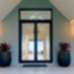 modern entryway featuring a black-framed glass door with a custom highlight window above