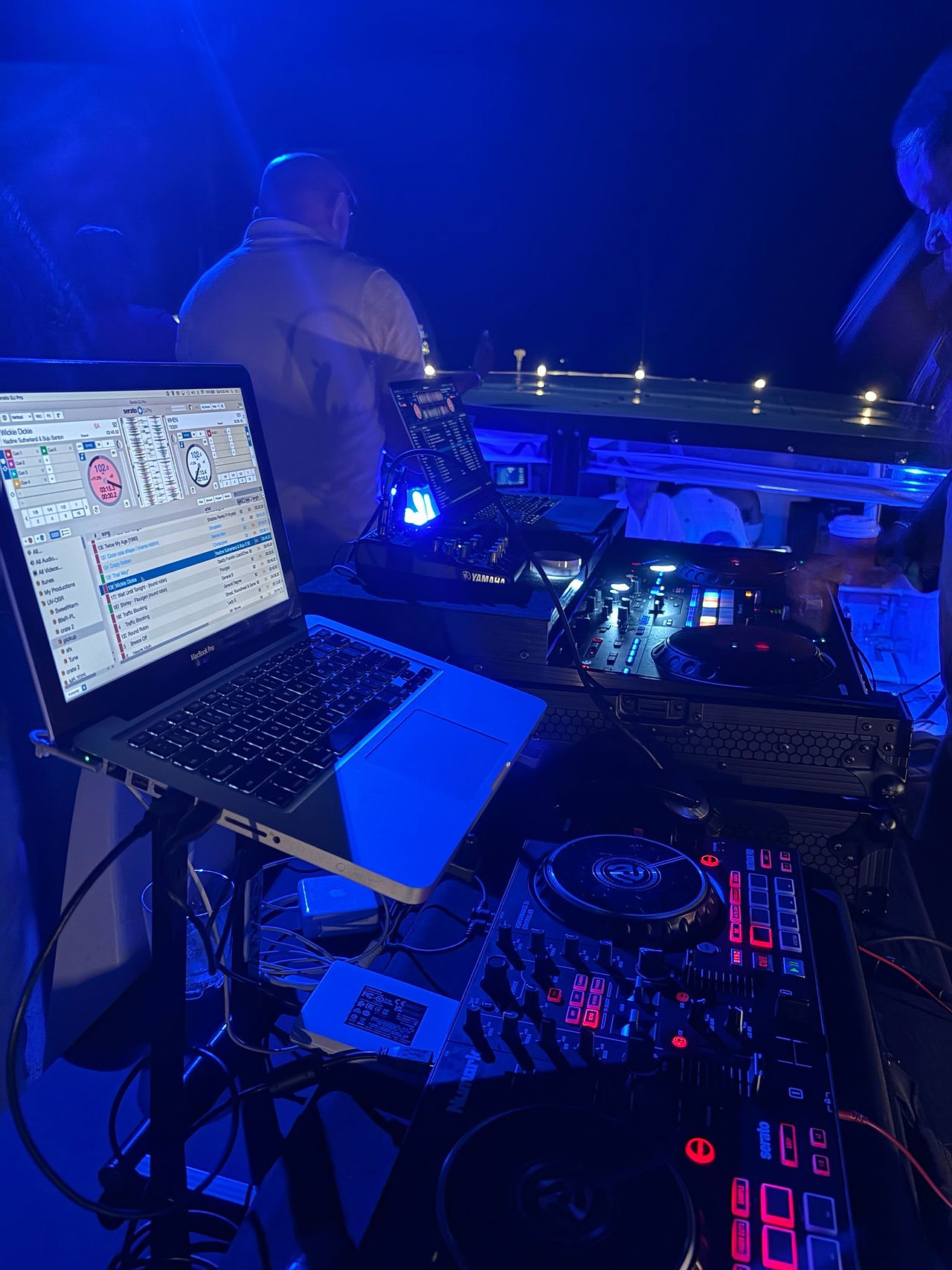 Old School Reggae Night aboard ÜberVida in Bermuda with guests dancing on a yacht under the stars to classic 90s reggae music while enjoying cocktails and island nightlife.