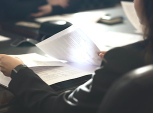 a woman sitting at a table reading a pap