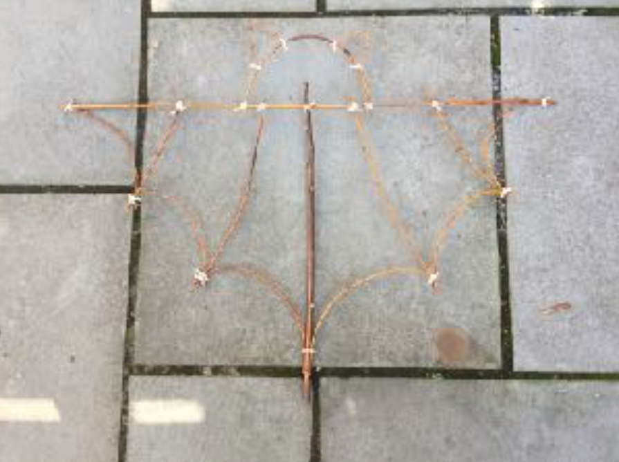 Willow branches bent and tied together to create a bat!