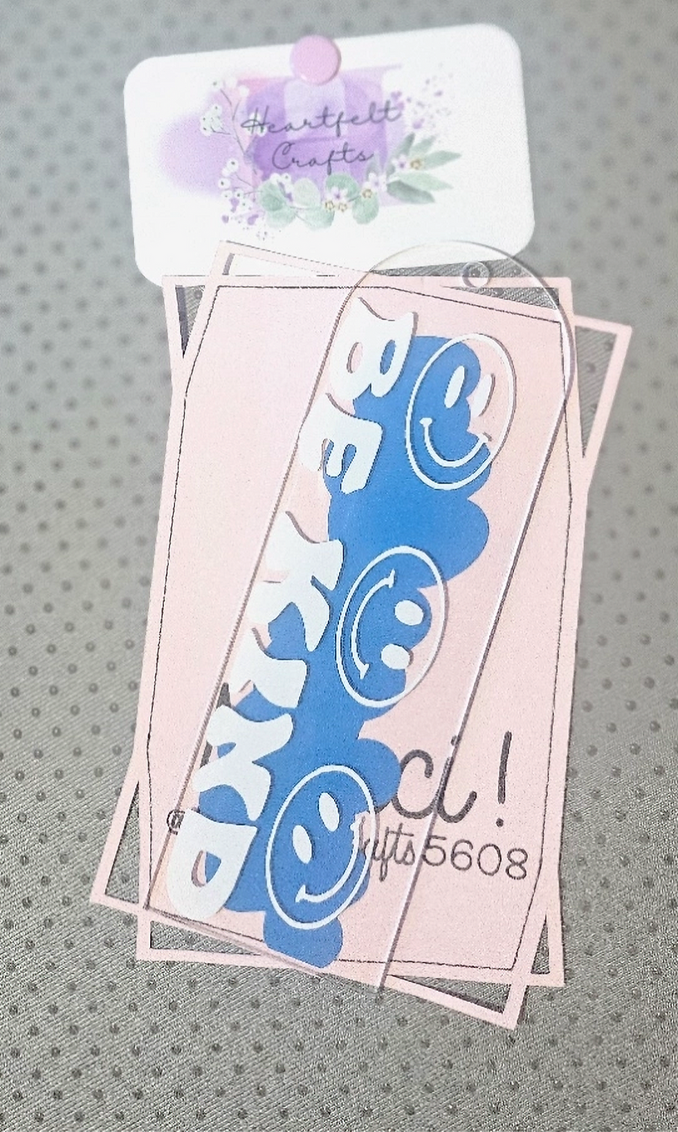 Be Kind bookmark with smiley faces on pink background.
