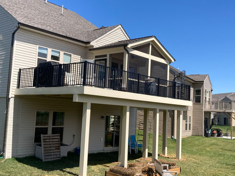 Second level cream porch with a black fence around the whole perimeter. A section is screened in for comport and the rest is open to enjoy the beautiful Northern Virginia Landscape.
