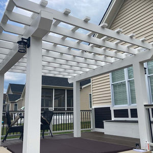 A charming white wood pergola in a lush backyard, providing a tranquil escape from the sun in Northern Virginia.
