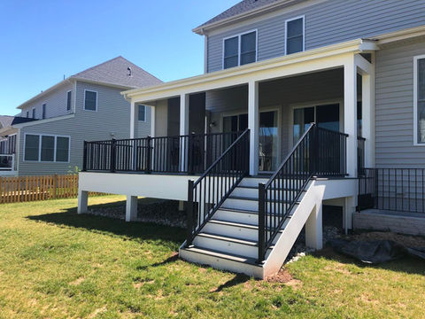 This is a custom composite white back deck with black fencing surrounding the perimeter. There is shading over the first half with the rest exposed to enjoy the Northern Virginia sun.