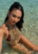 Thai model wearing a gold crystal chain top in clear beach water