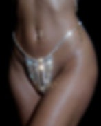Close up of a gold crystal thong worn by model body shot in gold