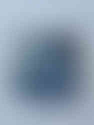 Scraps of denim sewn by hand on top of a piece of cardstock