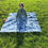 Thumbnail: A women sitting on a denim quilt at Dolores Park