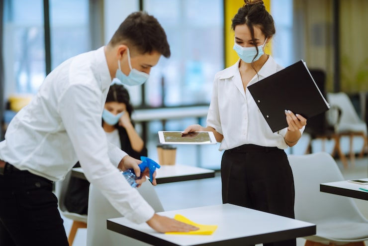 cleaning-disinfection-desktop-man-protective-sterile-mask-cleans-working-desk_217236-3300.
