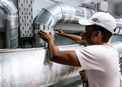skilled-technician-performing-maintenance-metal-air-duct-system-commercial-building-worksh